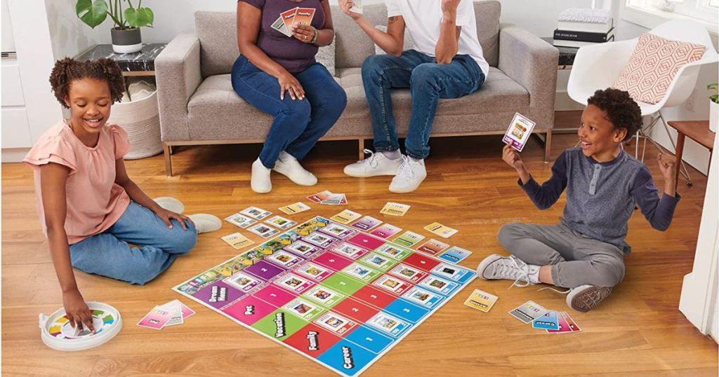 family palying giant Life board game inside