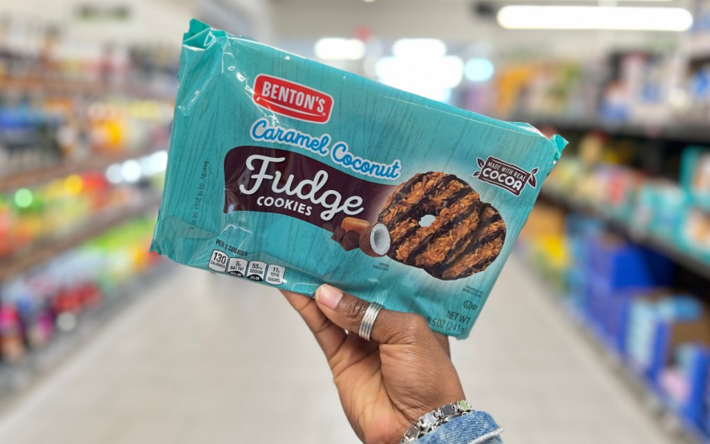 hand holding chocolate coconut cookies in aisle