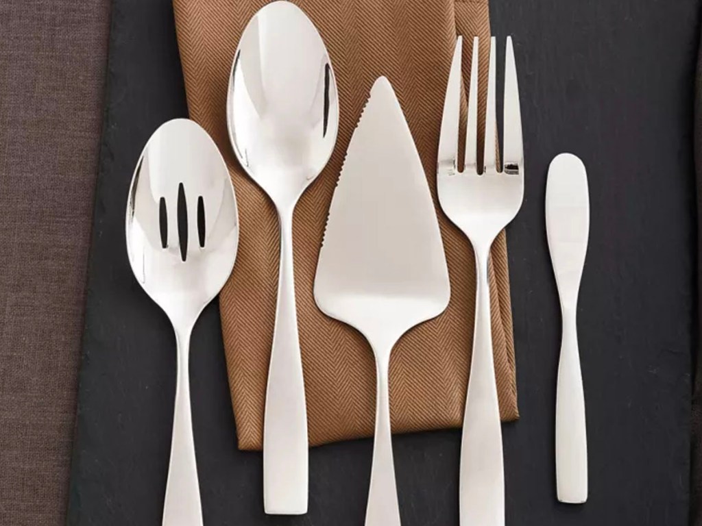 5 piece silver serving set on napkin