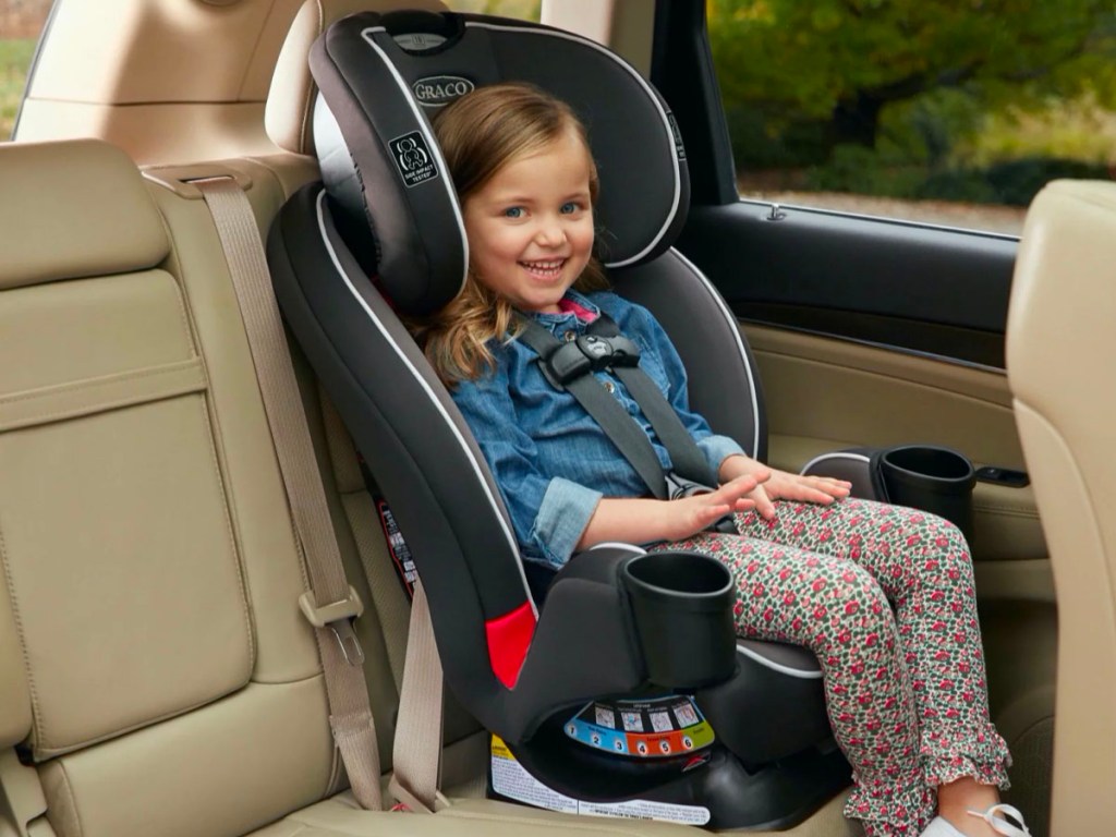 toddler in graco trigrow carseat in backseat of car
