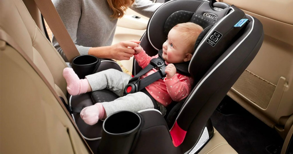 infant in graco trigrow carseat in backseat of car