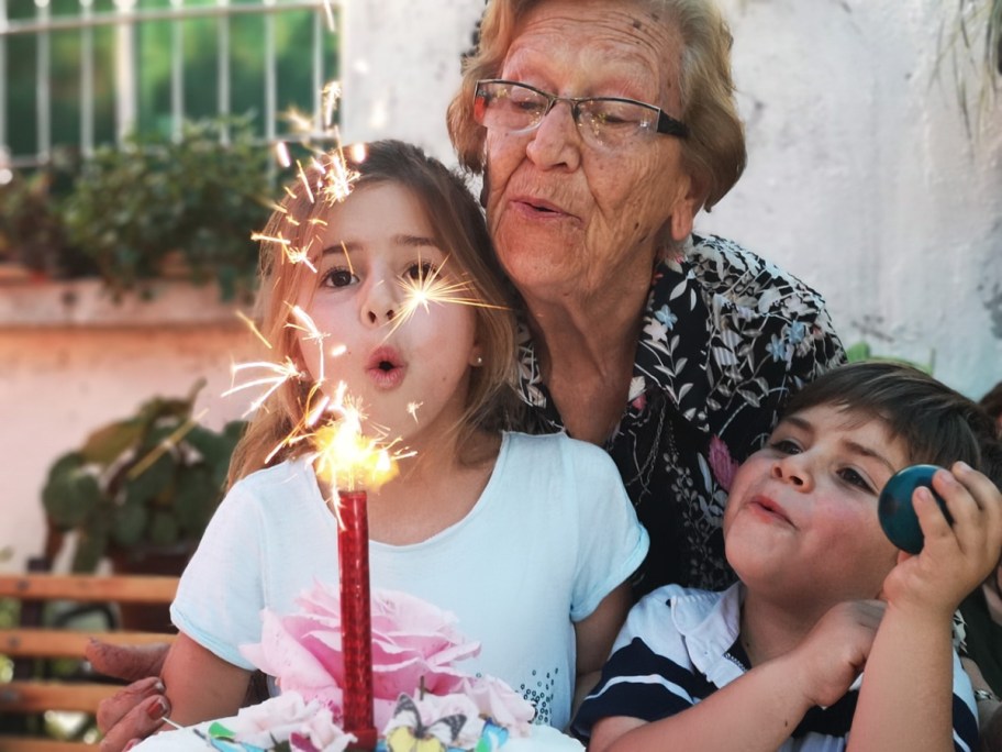 a grandmother blowing out her birthday candle