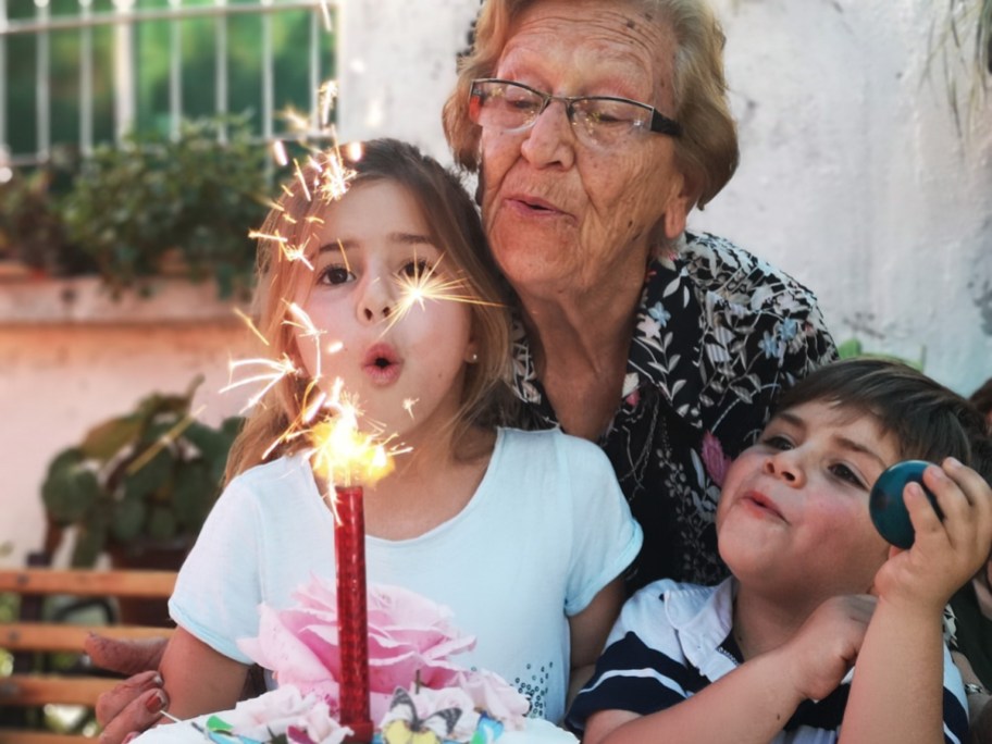 a grandmother blowing out her birthday candle