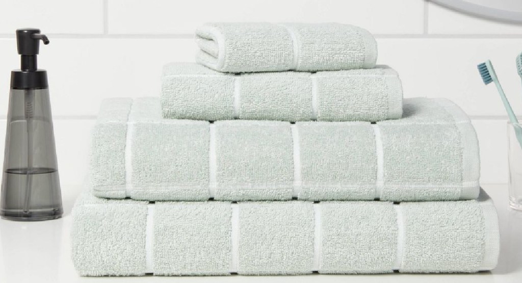 grid mint color four towels in bathroom
