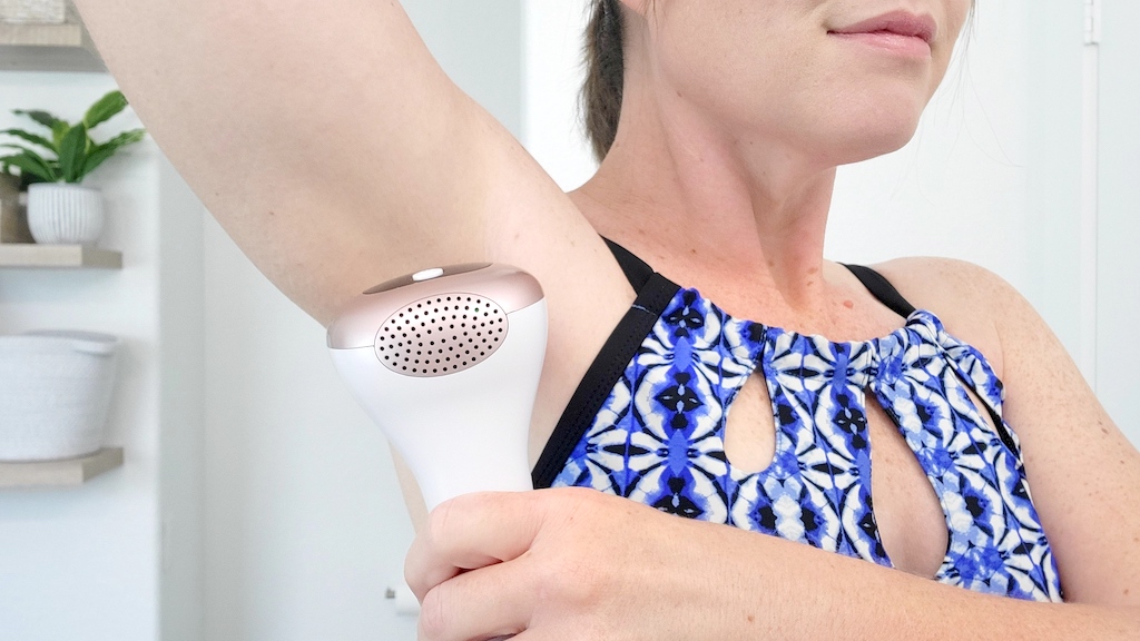 using hair remover device on armpit