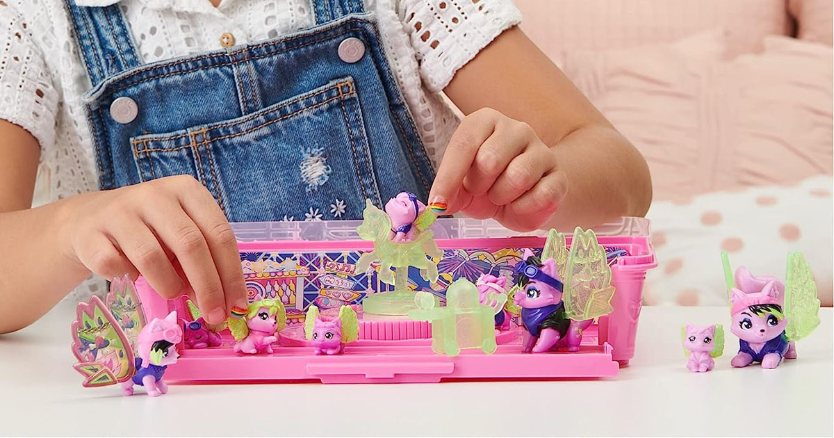 girl playing with wolf figures in hatchimals toy