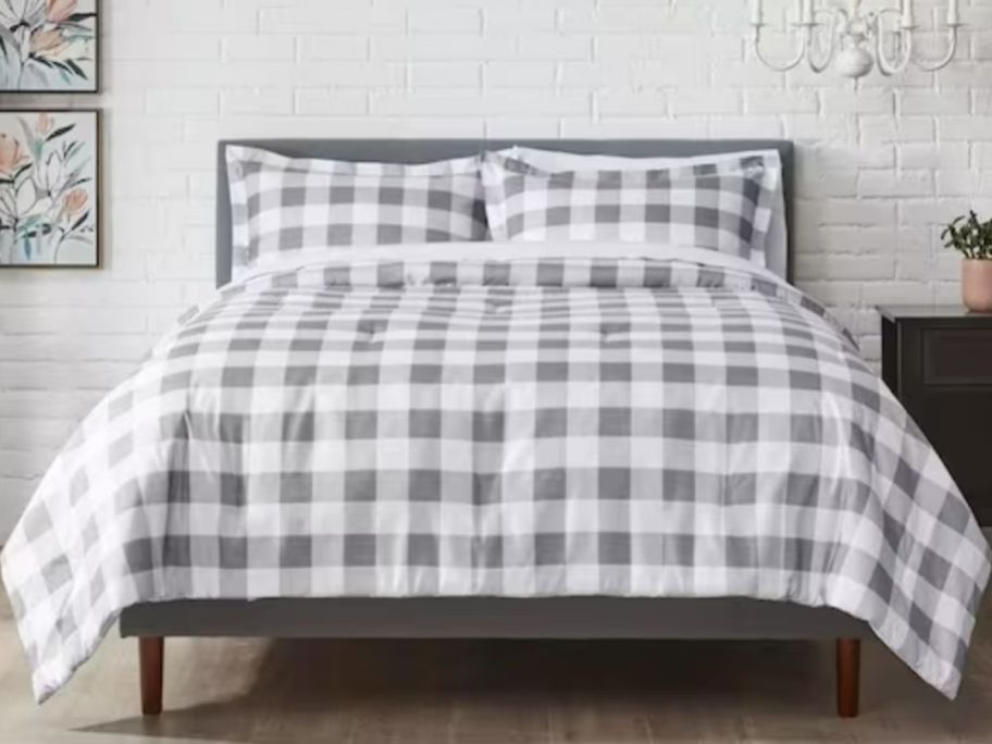 bed with grey and white gingham comforter and shames