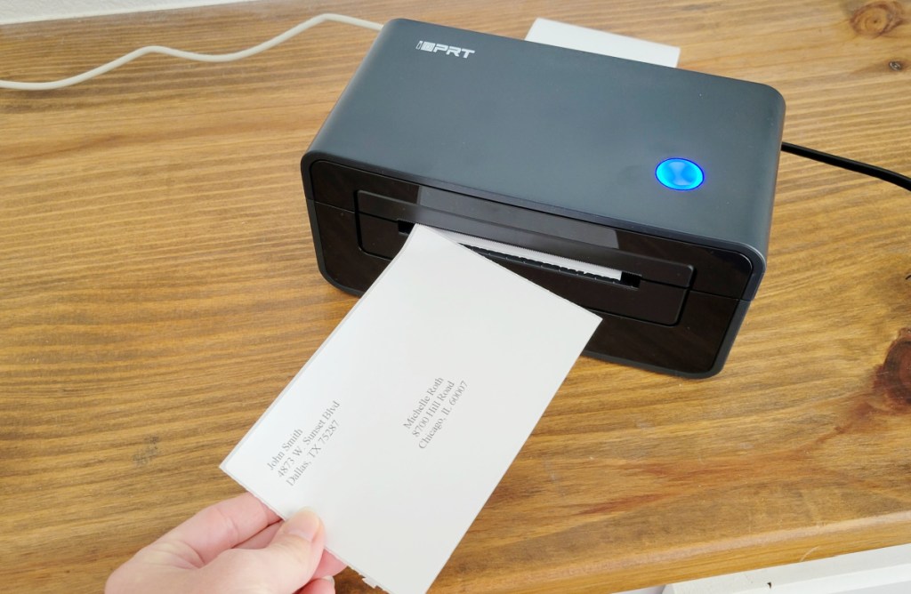iDPRT Thermal Label Printer with label printing in hand