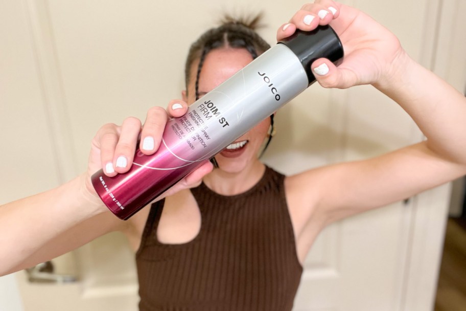 woman holding joico hairspray can