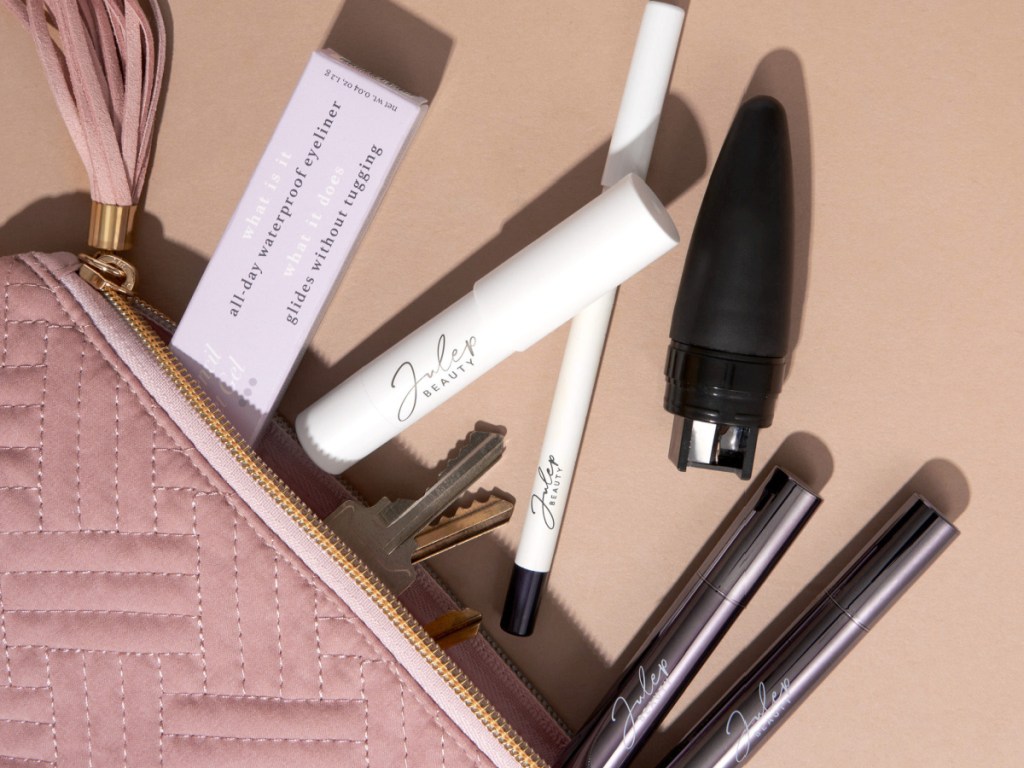 many beauty products spilling out of purse 