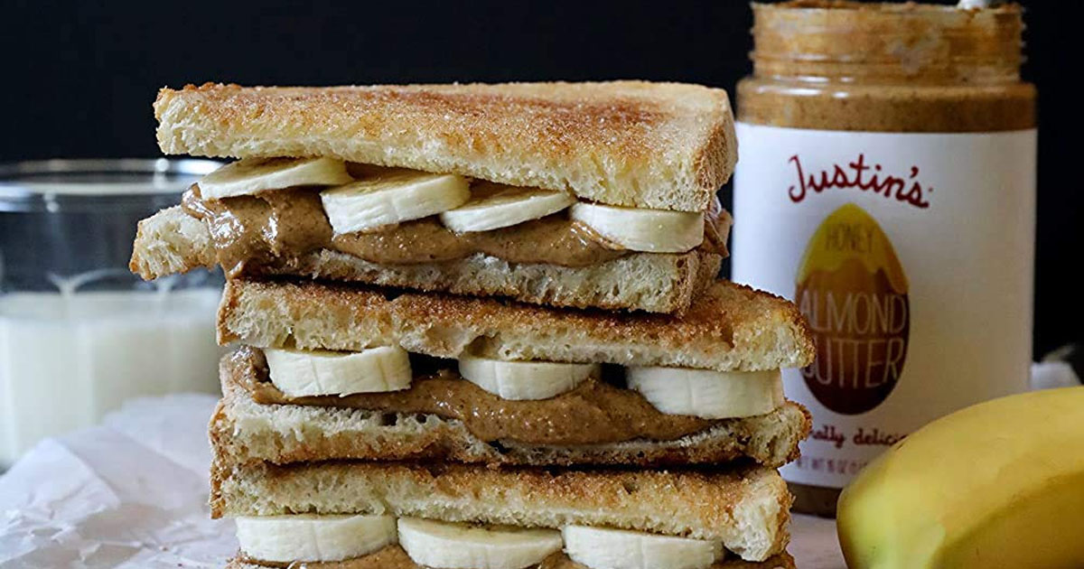 almond butter and banana sandwhich with justins almond butter jar in background