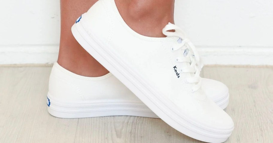 woman wearing white keds canvas sneakers