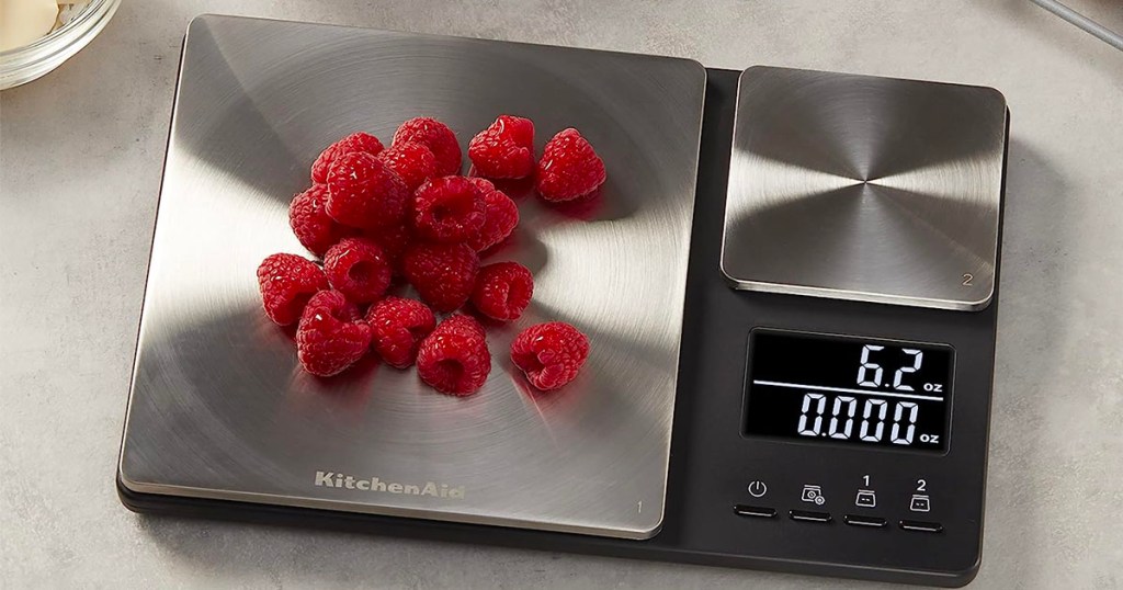 black and stainless steel food scale with raspberries
