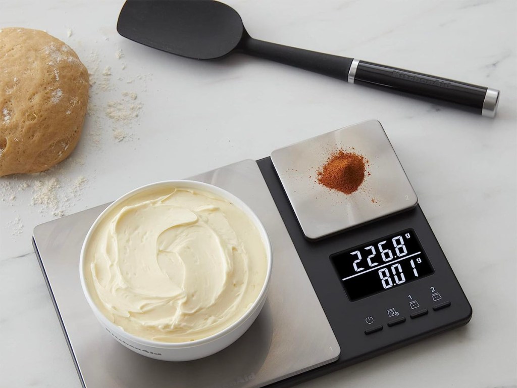 black and stainless steel food scale with icing and cinnmaon
