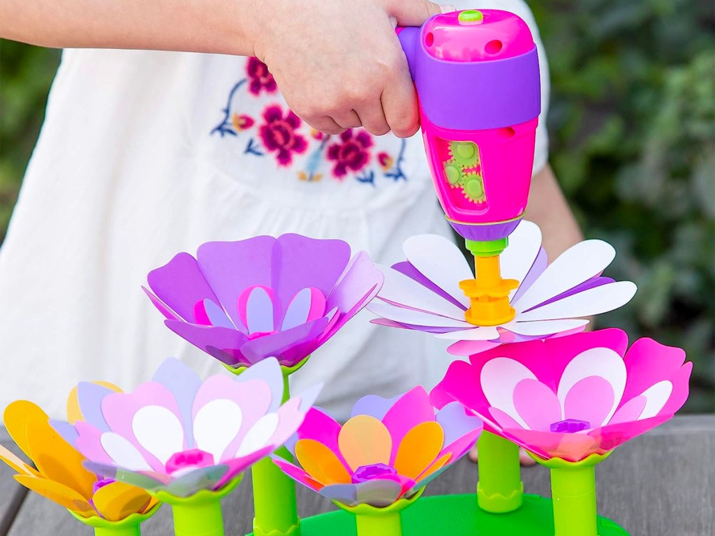 child using play drill flower toy