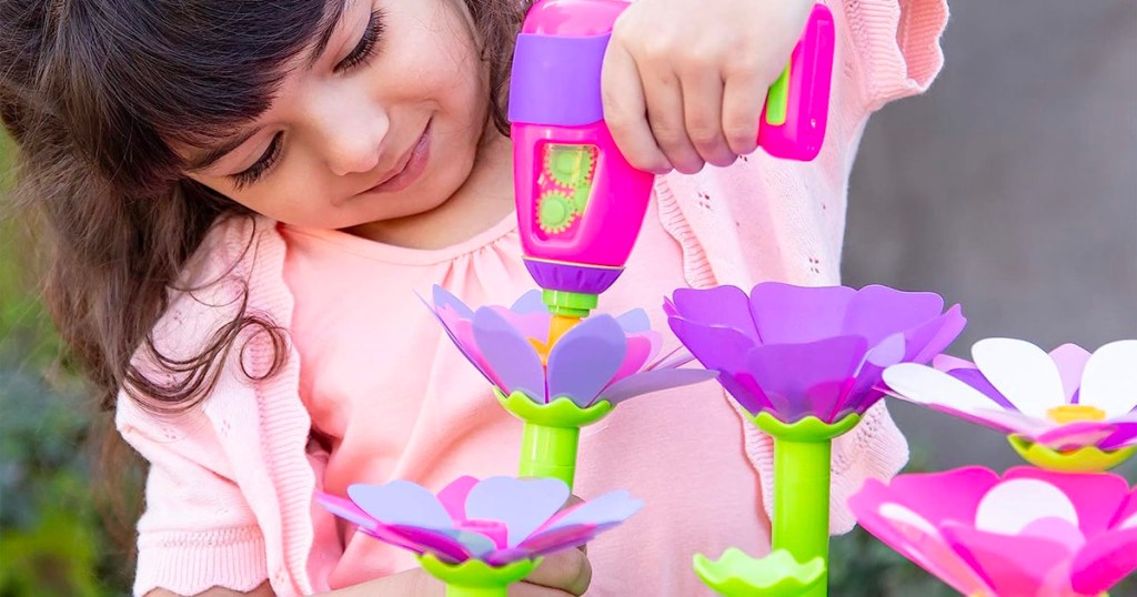 child using play drill flower toy