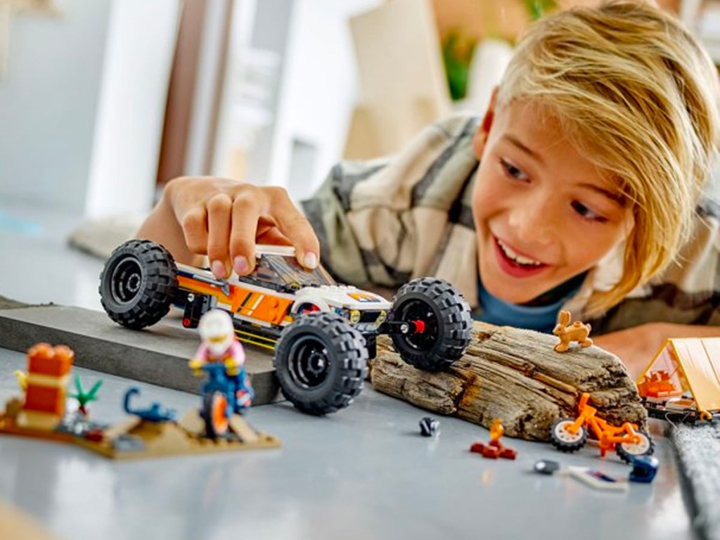 child playing with lego off roader adventure car lego set