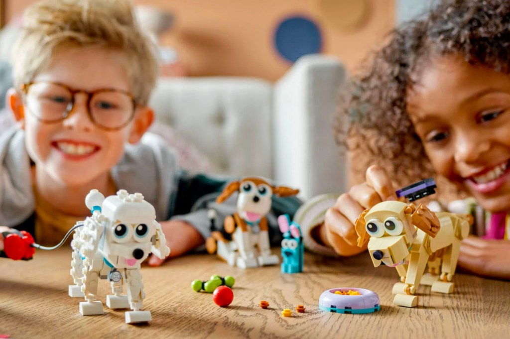 two kids playing with lego dog set