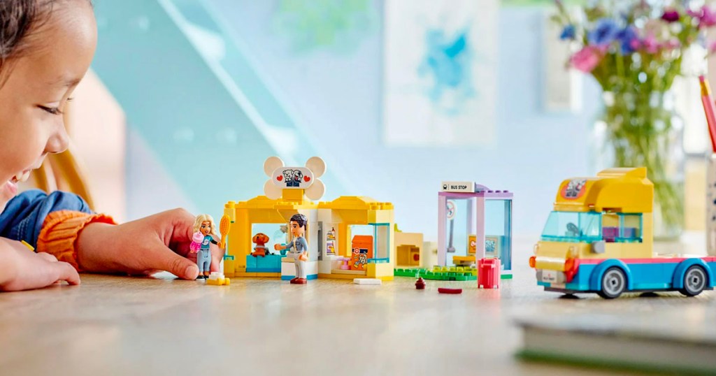 child playing with lego friends dog rescue set