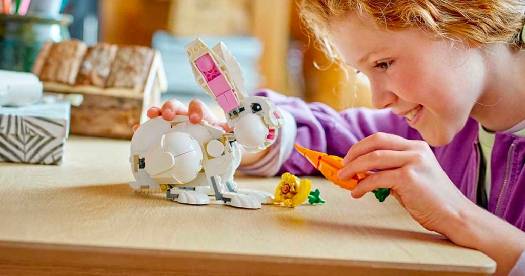 child playing with lego white rabbit and carrot