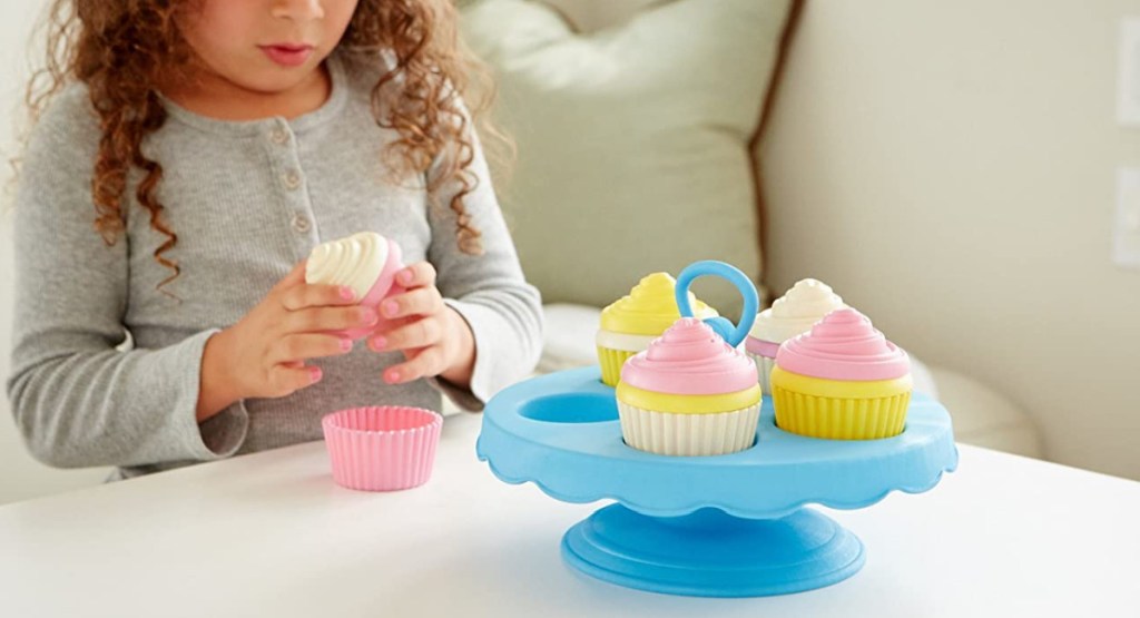 little girl playing with Green Toys Cupcake Set in living room