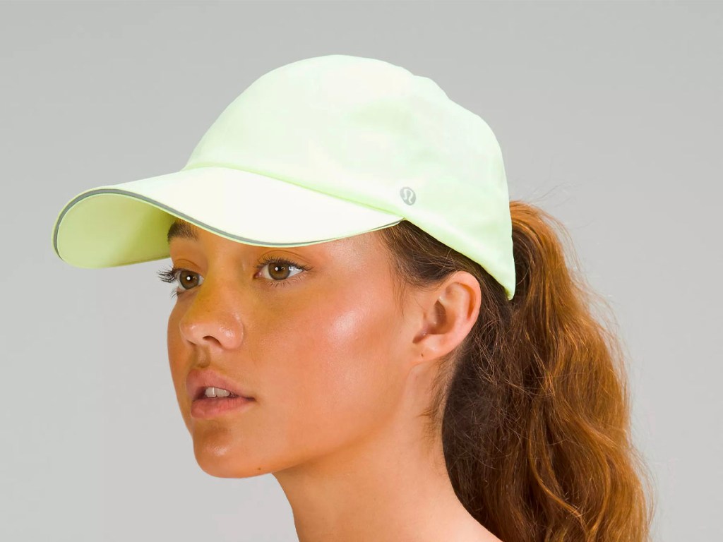 woman wearing lime green ball cap