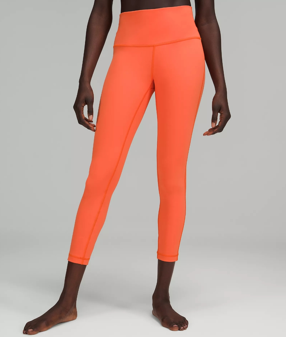 woman wearing a bright orange pair of leggings