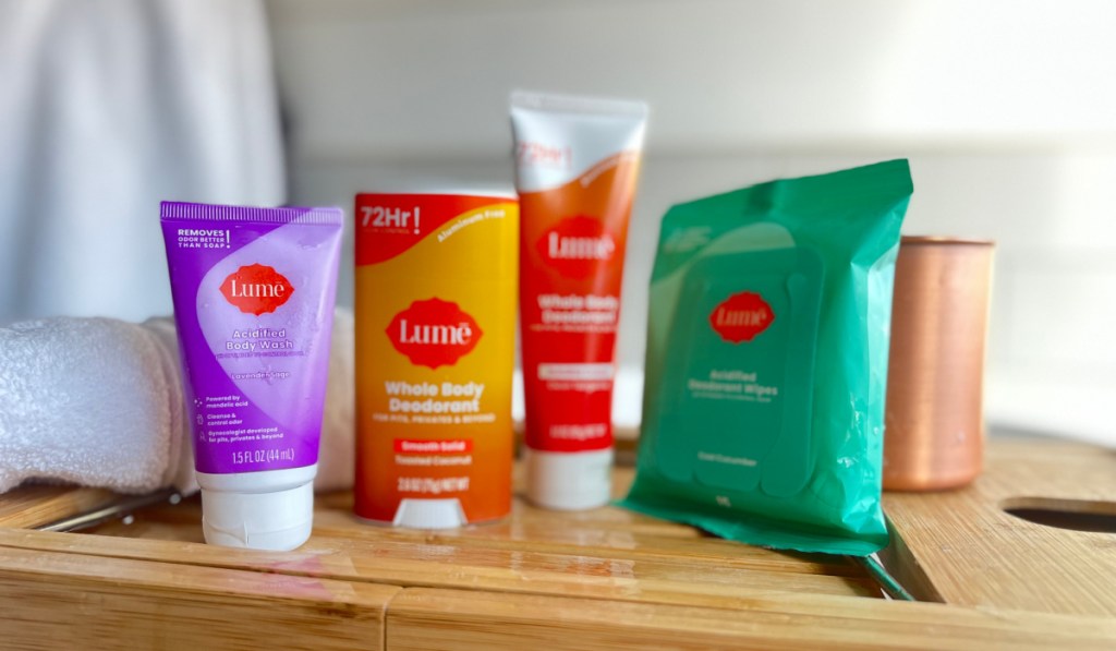 cream, stick, and tube deodorants with body wipes on bamboo tray