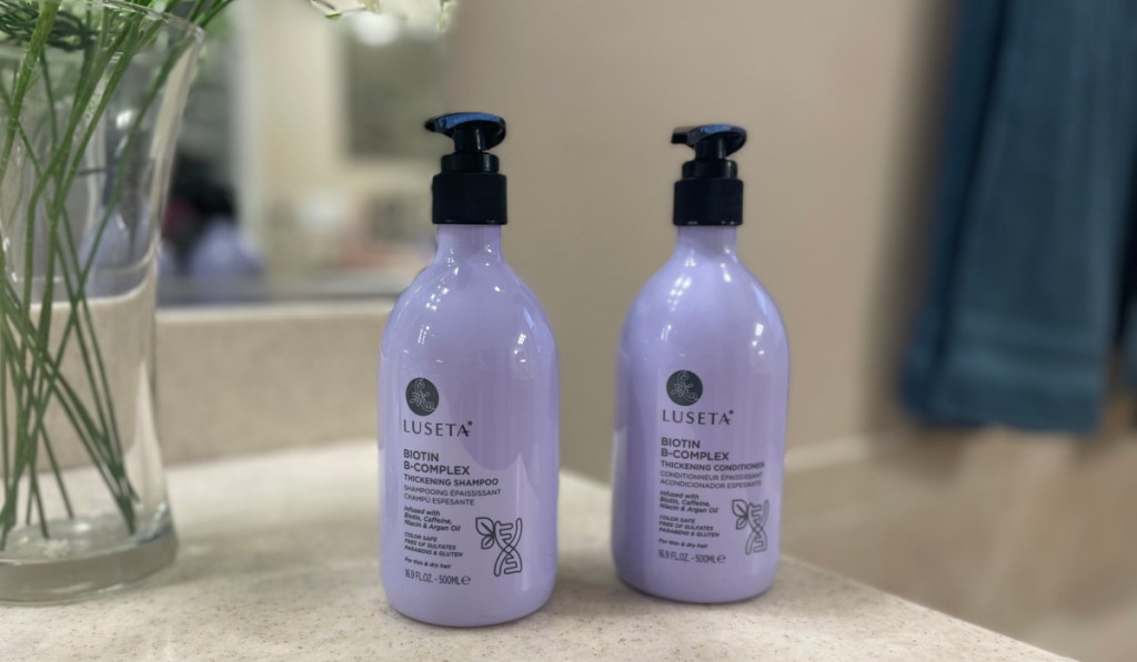 purple bottle of shampoo and conditioner 