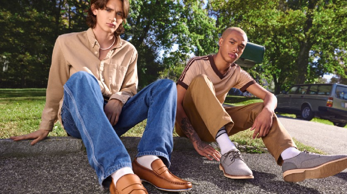 Two men sitting outside wearing Madden NYC Shoes