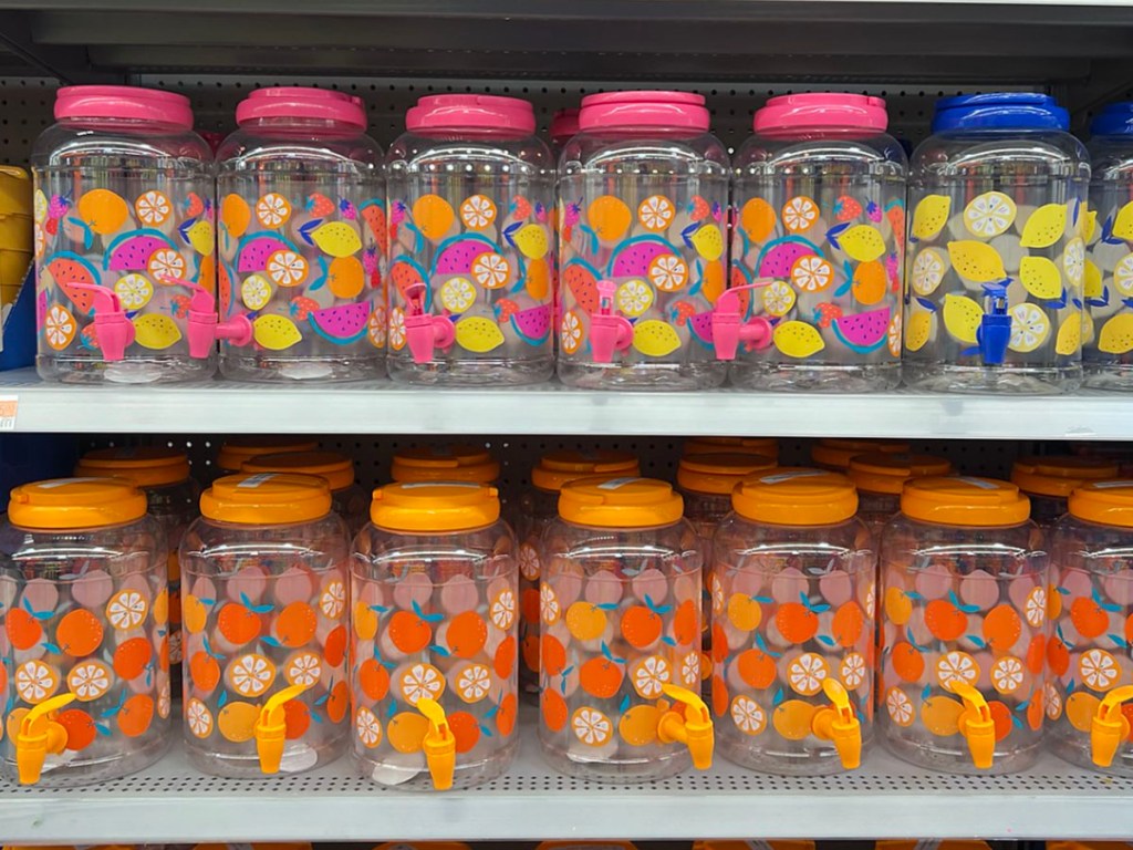 two rows of mainstays beverage dispensers pink, blue and orange with fruit images