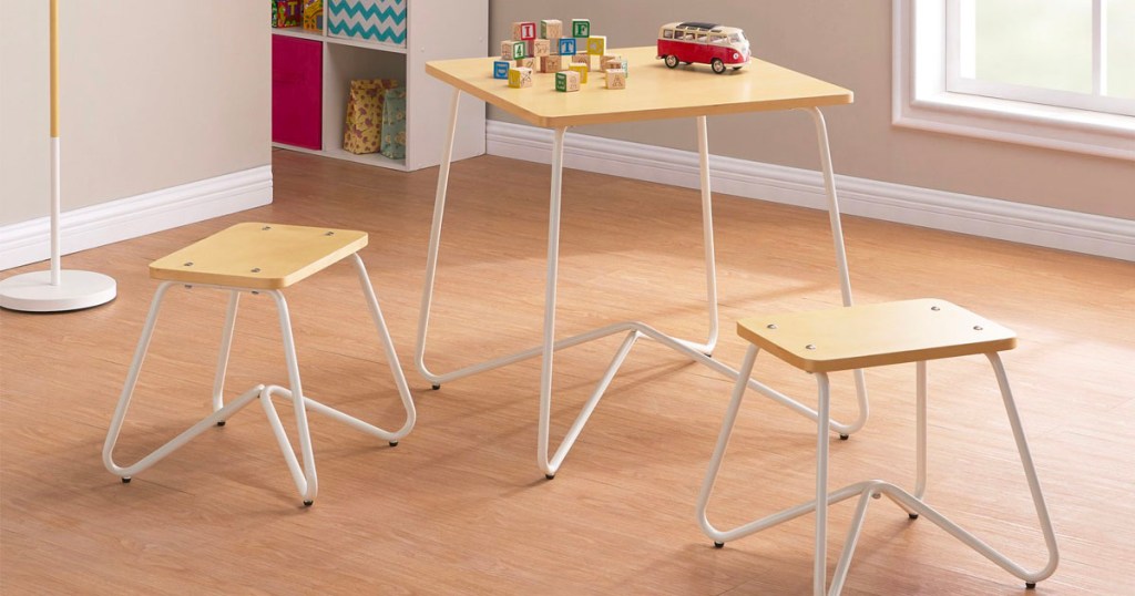 wood and white metal kids play table in playroom with toys