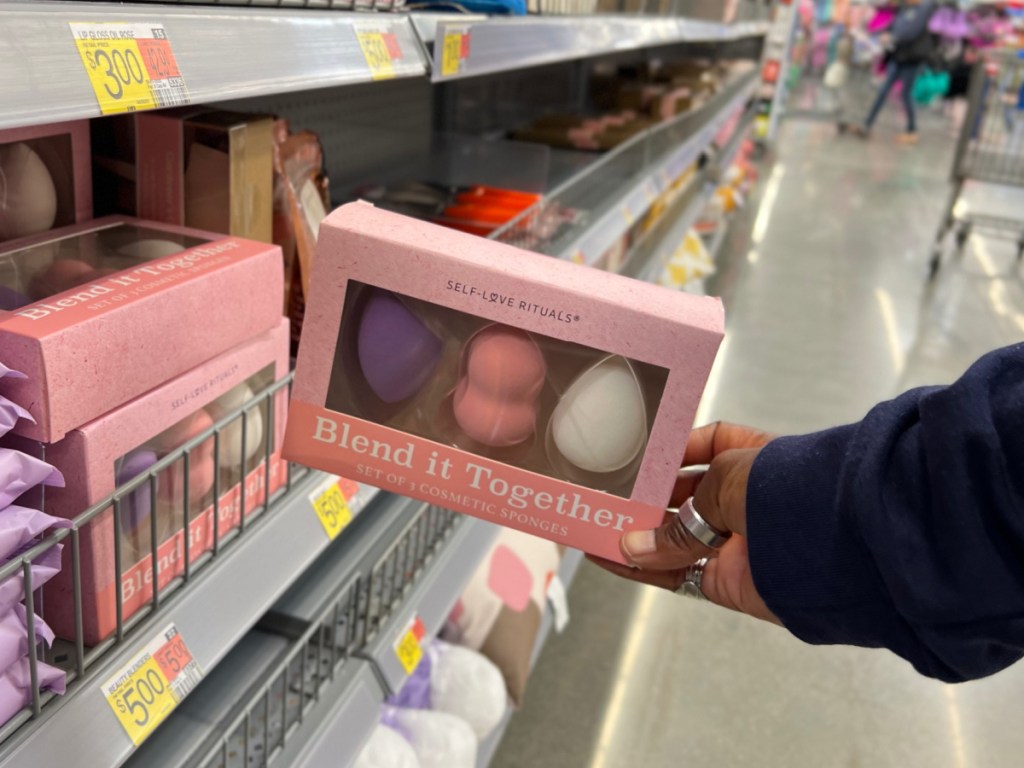 makeup sponge set in woman's hand at store