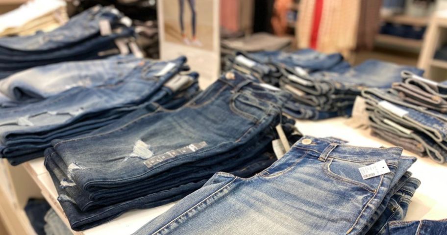 pairs of women's jeans on display table at maurices