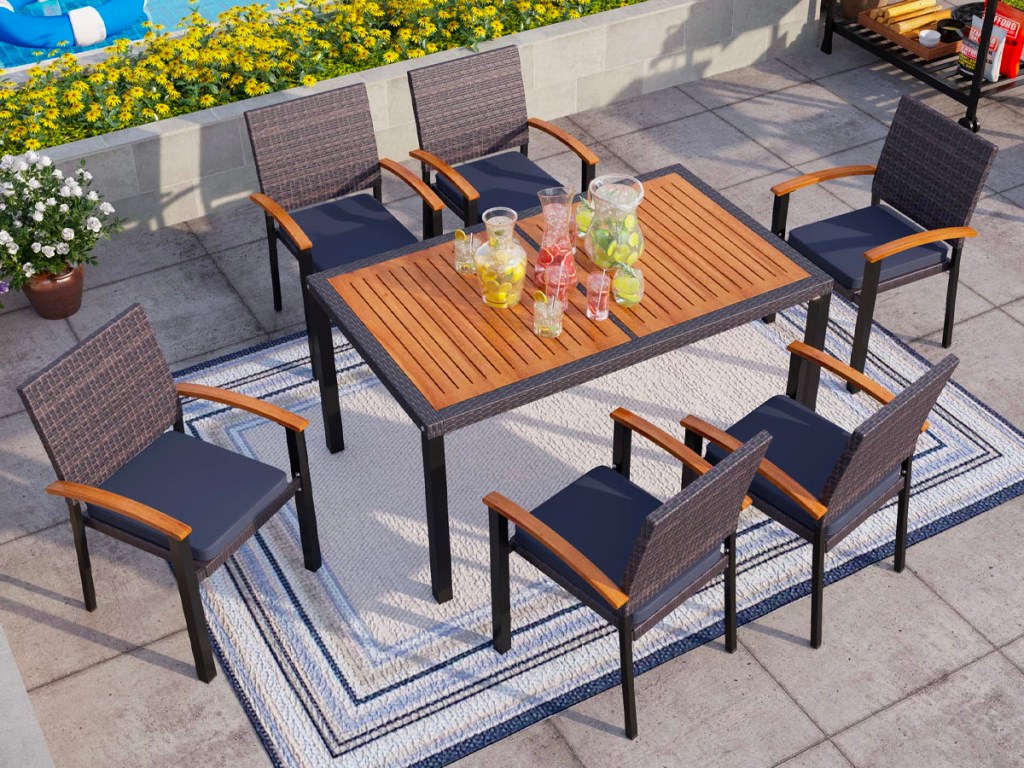 mf studio navy and wood outdoor dining table with 7 chairs on patio