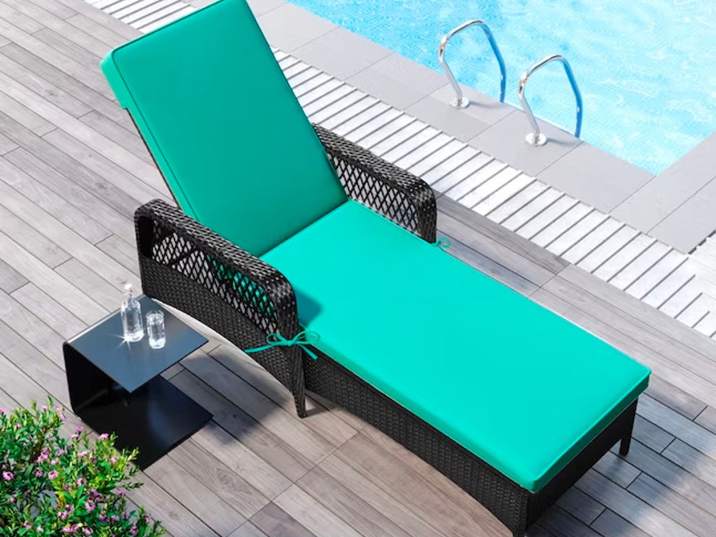 teal lounge chair next to pool