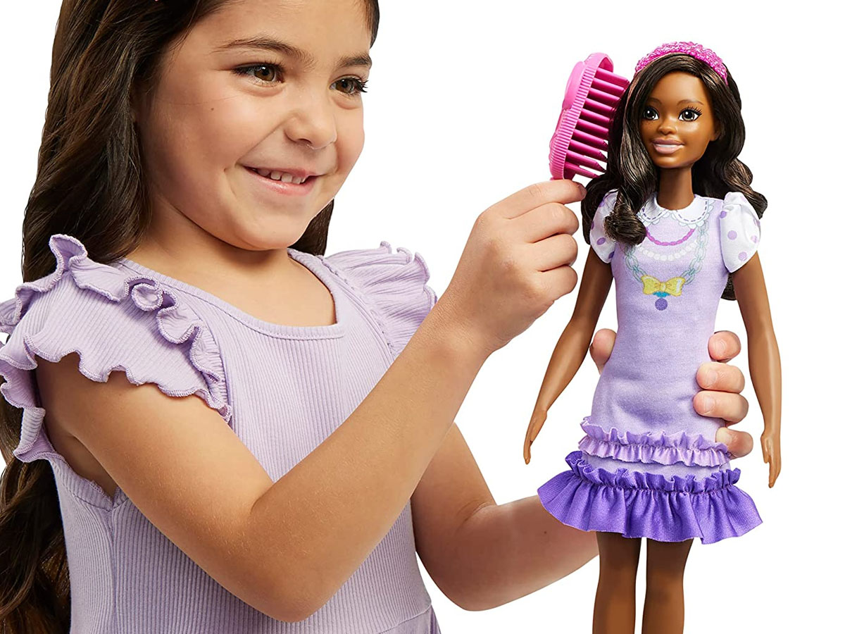 girl playing with my first barbie in purple dress