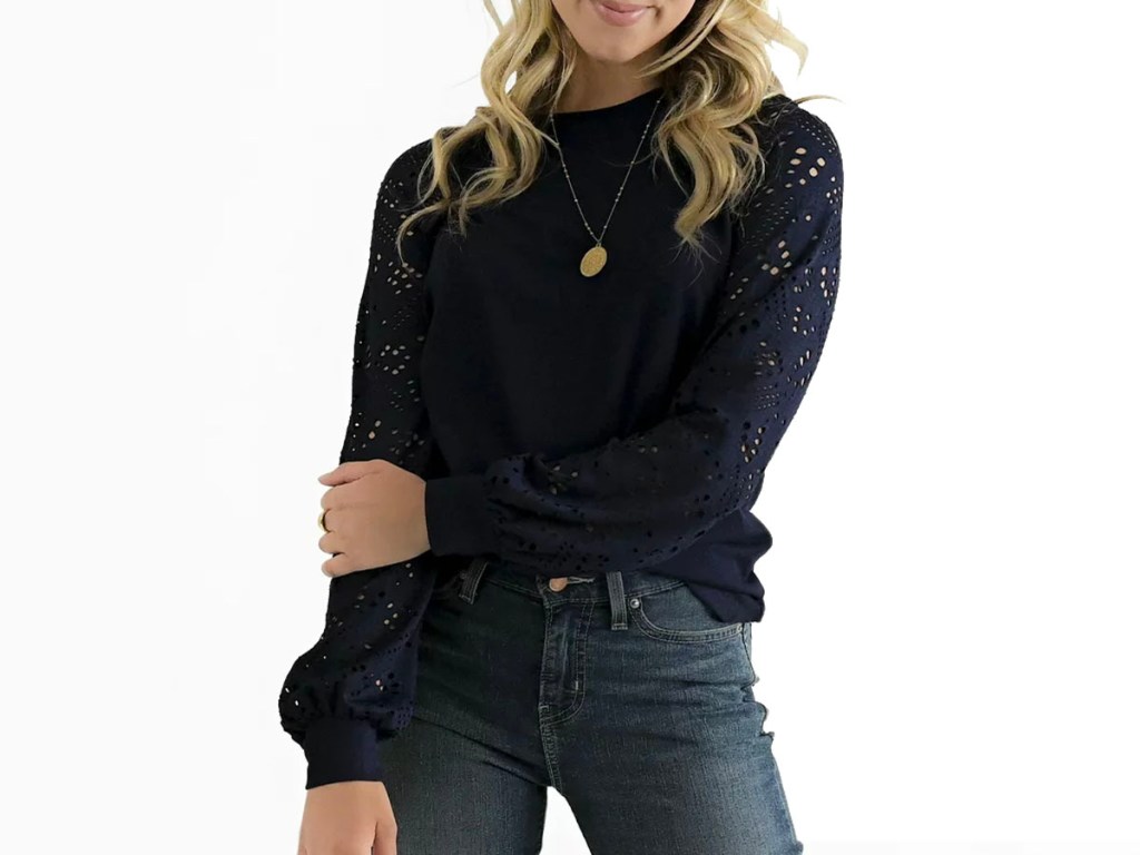woman wearing black long sleeve sweatshirt and jeans