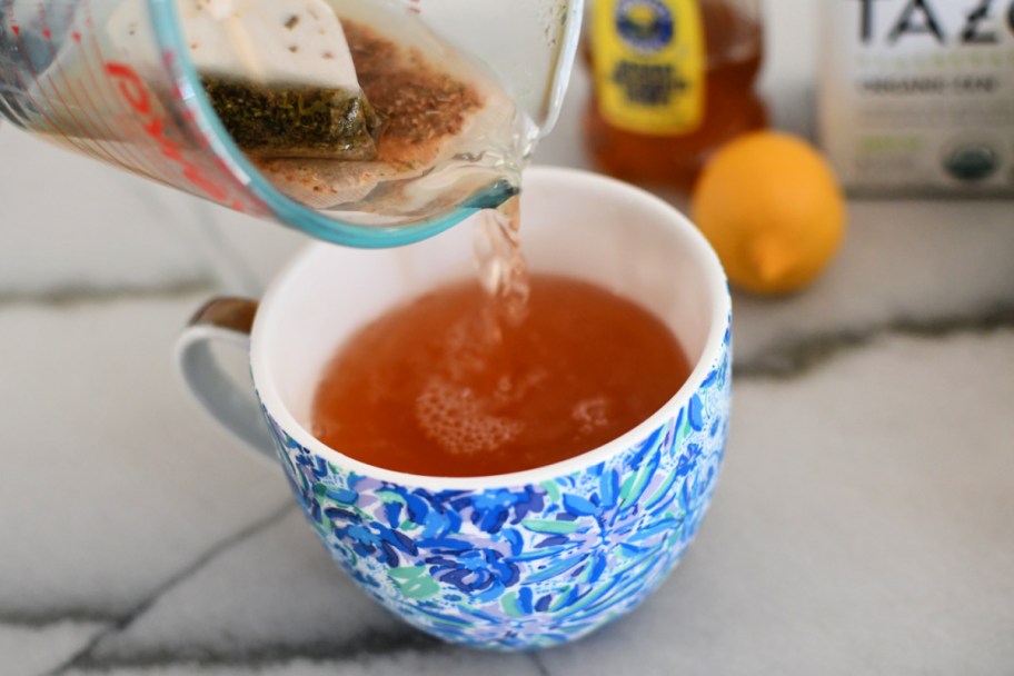 pouring tea into a coffee cup