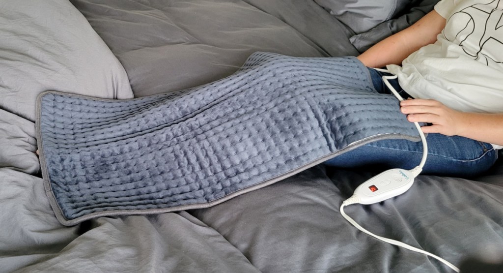 woman with extra large heating pad on legs