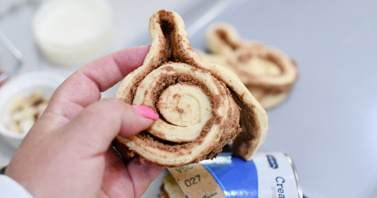shaping a bunny ear with a cinnamon roll