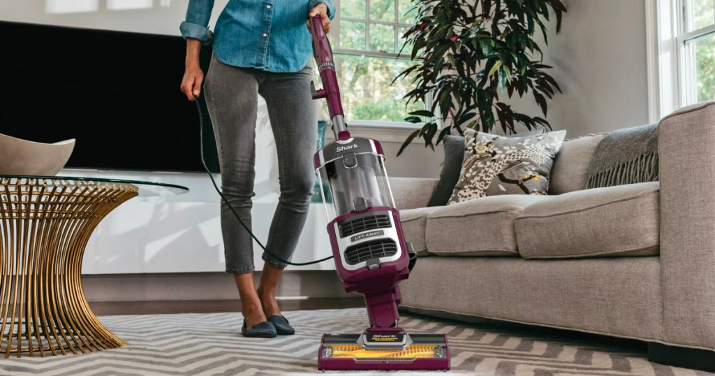 women pushing vacuum in living room