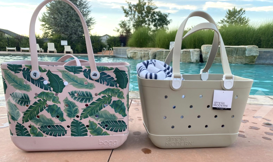 palm print bogg bag next to beige simple modern tote on concrete by pool