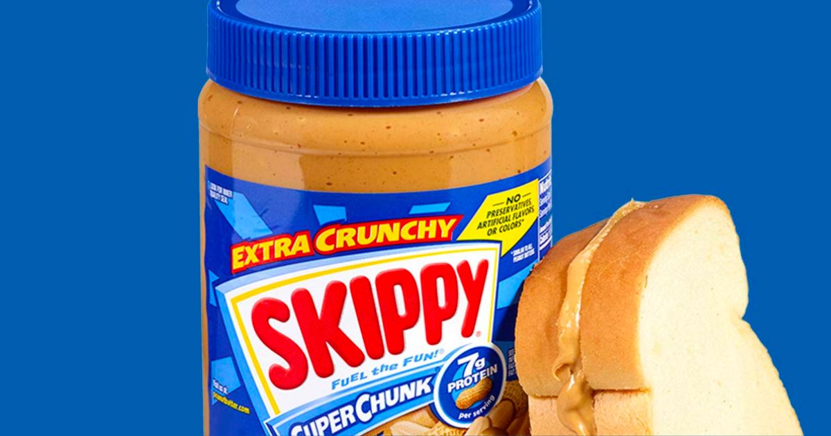 skippy extra chunky 40oz peanut butter next to a peanut butter sandwich on white bread