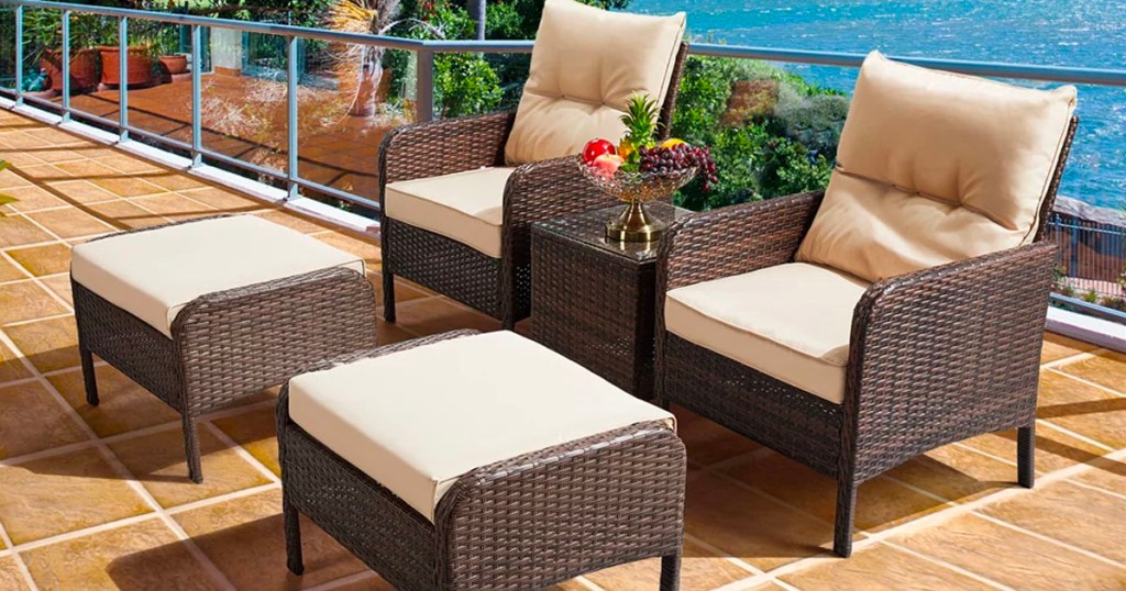 brown rattan patio set with beige cushions next to pool