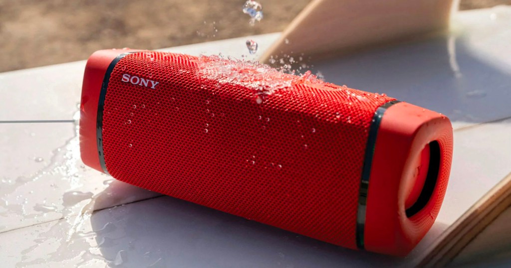 red sony portable speaker with water falling on it