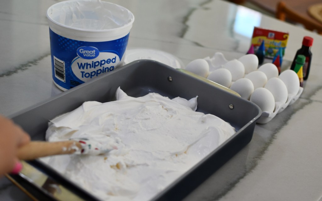 spreading whipped cream in sheet pan 