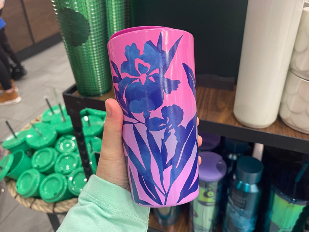 hand holding pink and purple flower tumbler