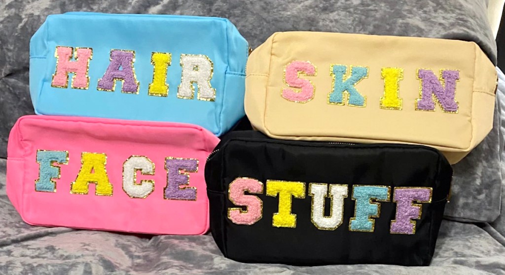 blue yellow pink and black stoney clover lookalike cosmetic bags on fur blanket