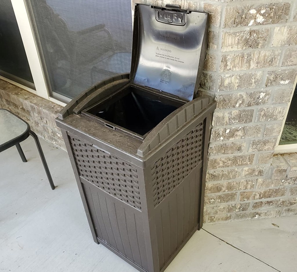 brown resin trash can with the lid open